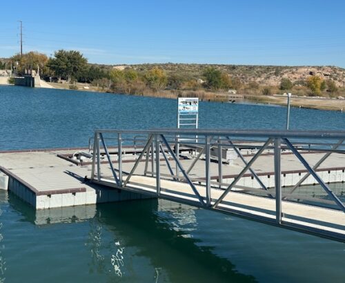 a ramp to a dock on a small lake