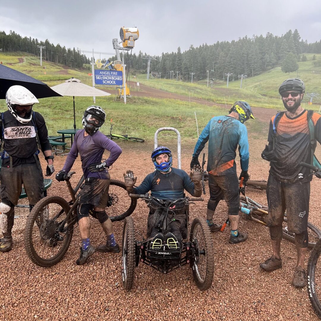 A group of mountain bikers embracing the mud after a wet day at Angel Fire's downhill trails