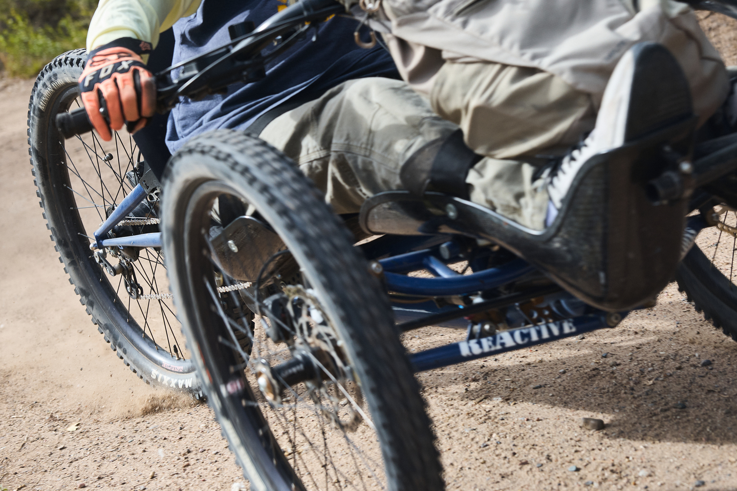 Action shot of an adaptive mountain bike on a dirt trail