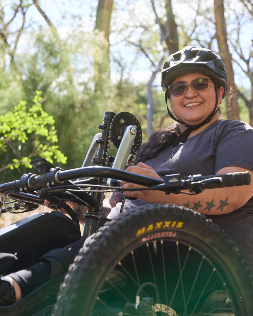 woman riding an adaptive mountain bike smiling