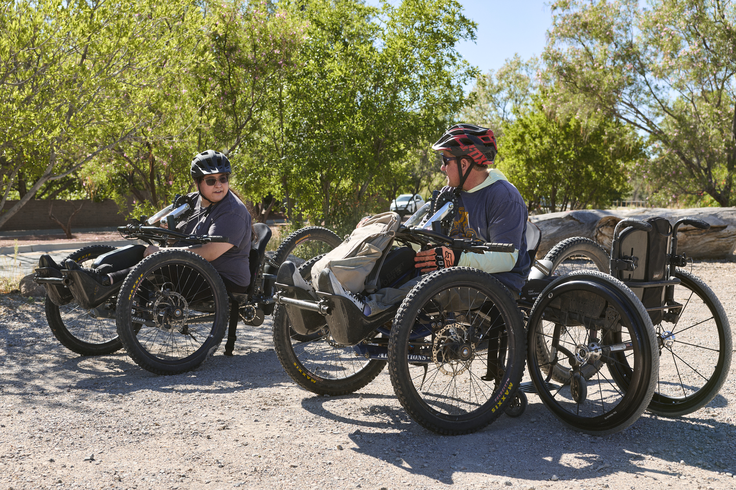 Man and woman in adaptive mountain bikes talking